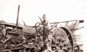 Roy Tilden on his kerosene-fueled steel wheel tractor sometime in the 1940s.